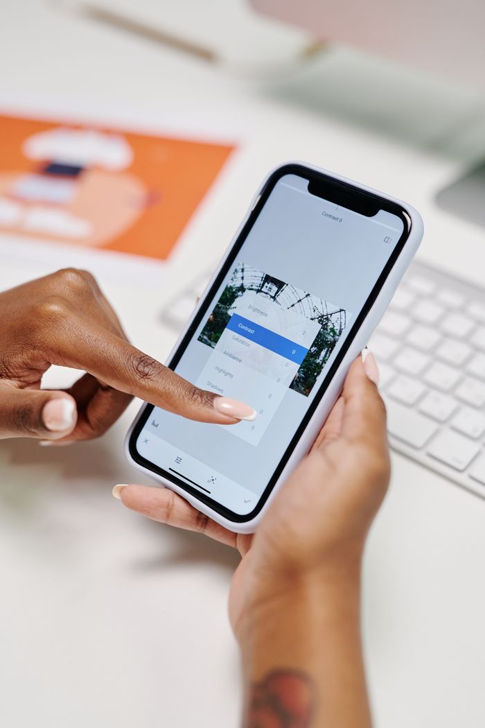 Close-up of hands interacting with a smartphone for online scheduling, showcasing modern digital convenience.